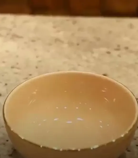 A ceramic mixing bowl on a stone counter