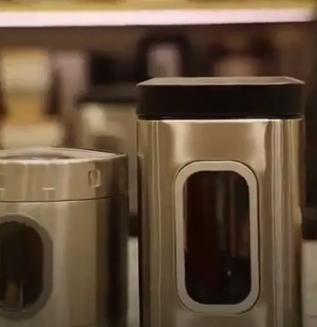 Two brushed steel storage canisters with viewing windows